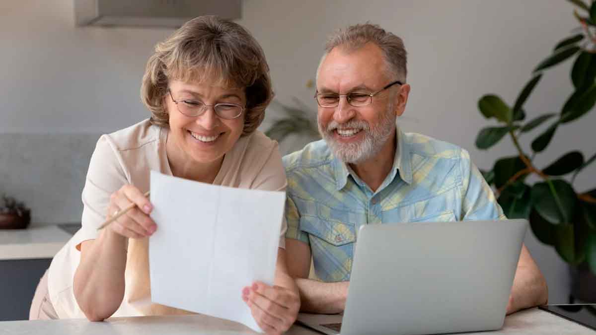 Pareja de jubilados revisando documentos sobre pensiones contributivas y no contributivas en 2026 desde casa