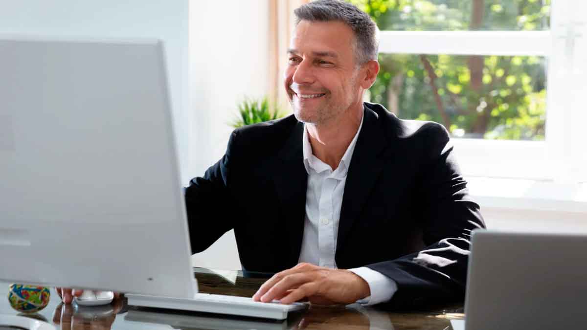 Trabajador utilizando un ordenador de empresa en su puesto de trabajo durante la jornada laboral