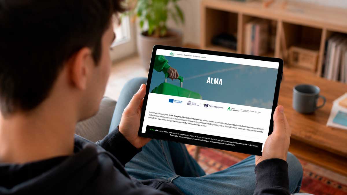 Joven consultando en una tablet el programa ALMA Andalucía con prácticas laborales y formación en Europa