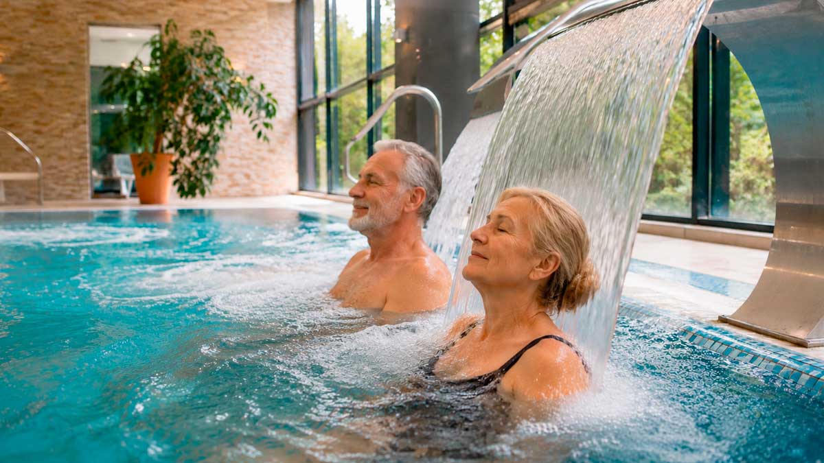 Pareja mayor disfrutando de una sesión de hidroterapia en un balneario del programa de termalismo del Imserso 2026