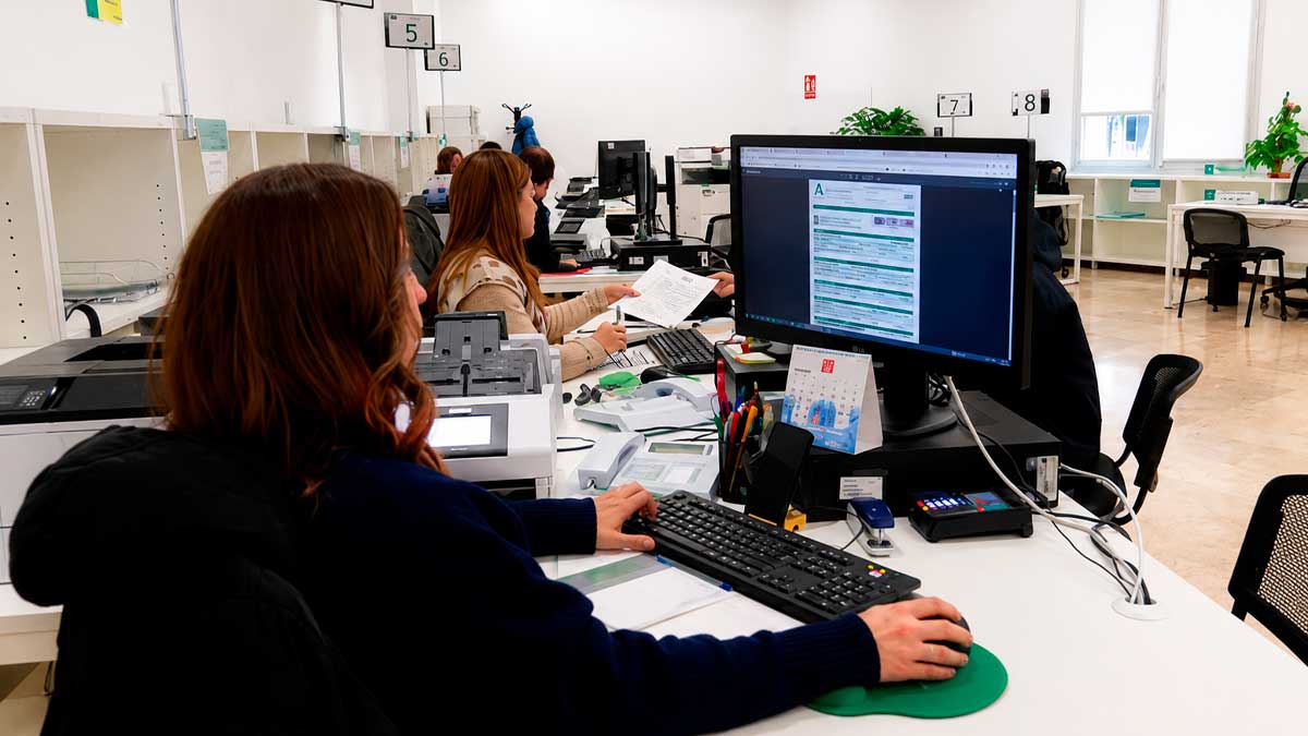 Empleados de la Junta de Andalucía trabajando en oficina, teletrabajo disponible un día semanal