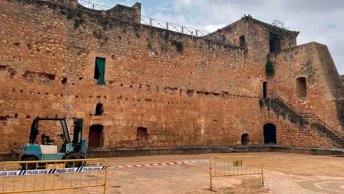 Castillo de Niebla con murallas en restauración y maquinaria en la zona