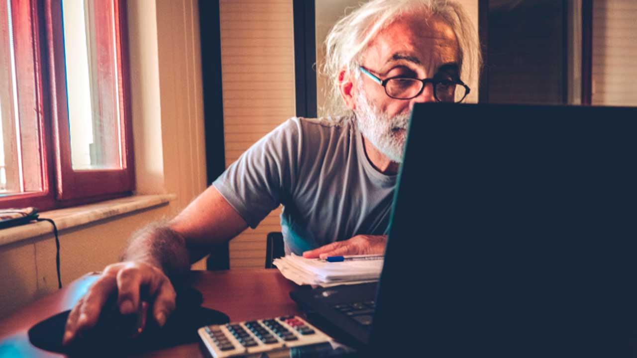 Hombre consultando su pensión de jubilación tras trabajar como asalariado y autónomo