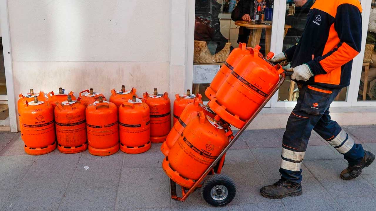 Repartidor transportando varias bombonas de butano para su entrega
